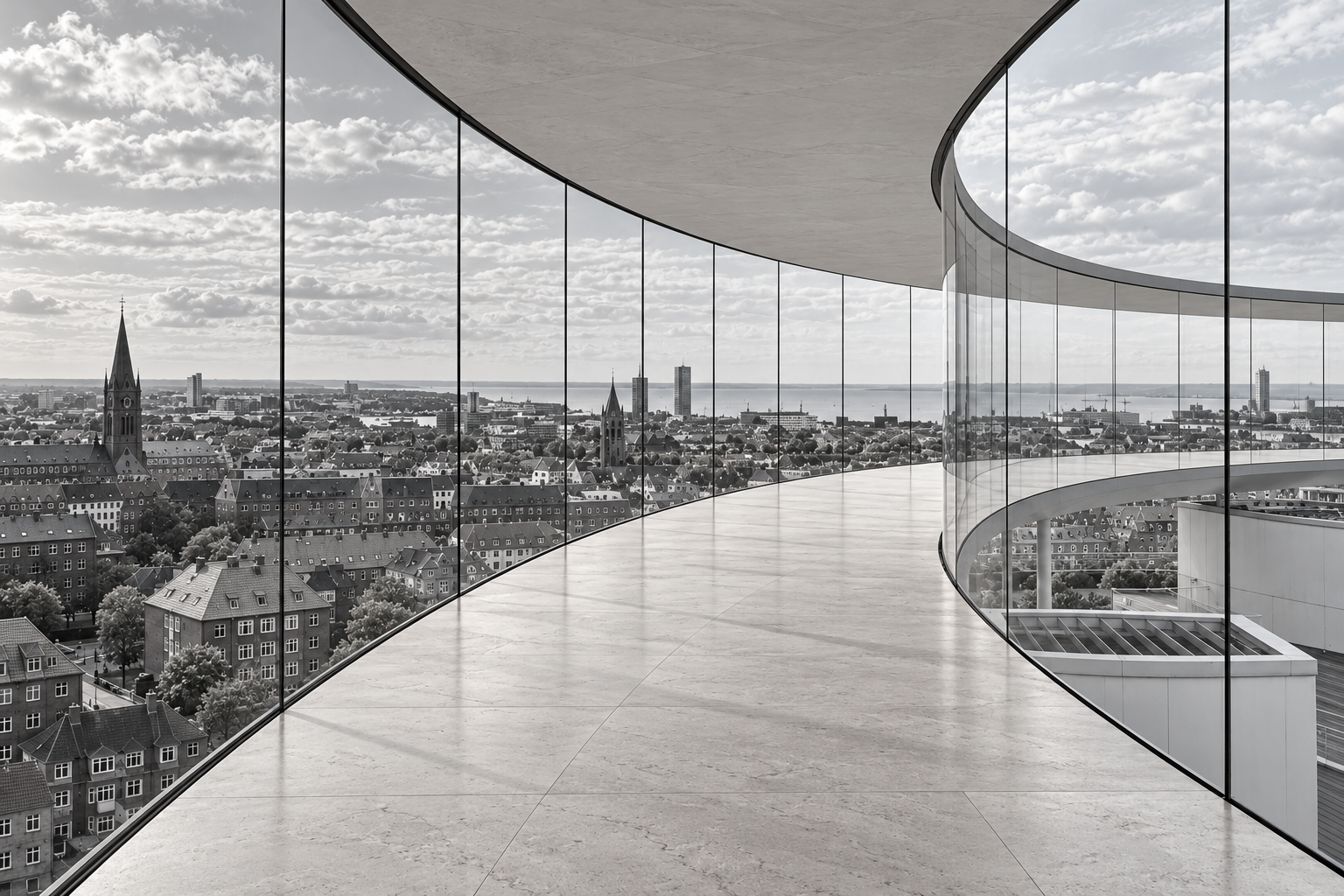 Panoramic city view through a curved glass gallery with a natural stone floor